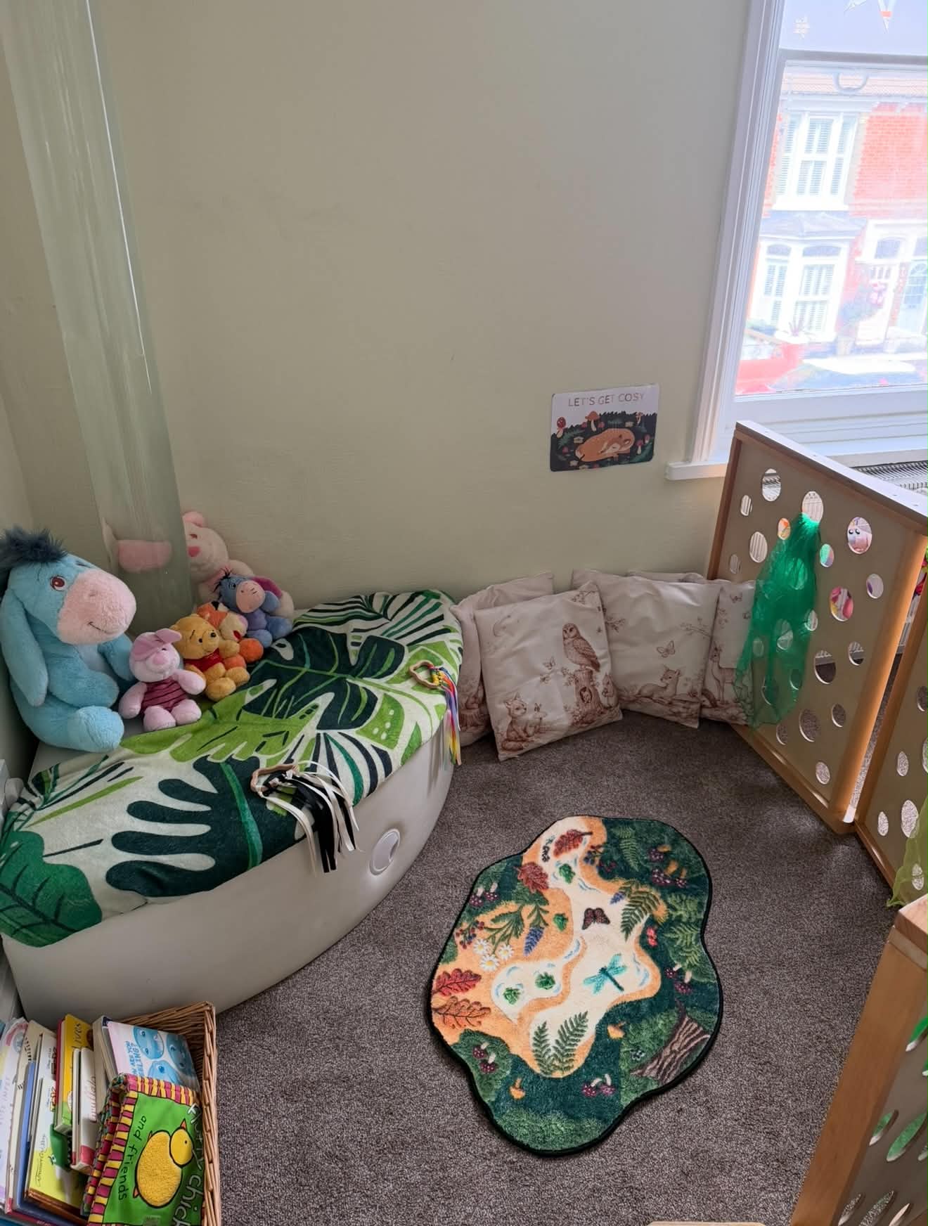 Cosy reading corner with cushions and soft toys
