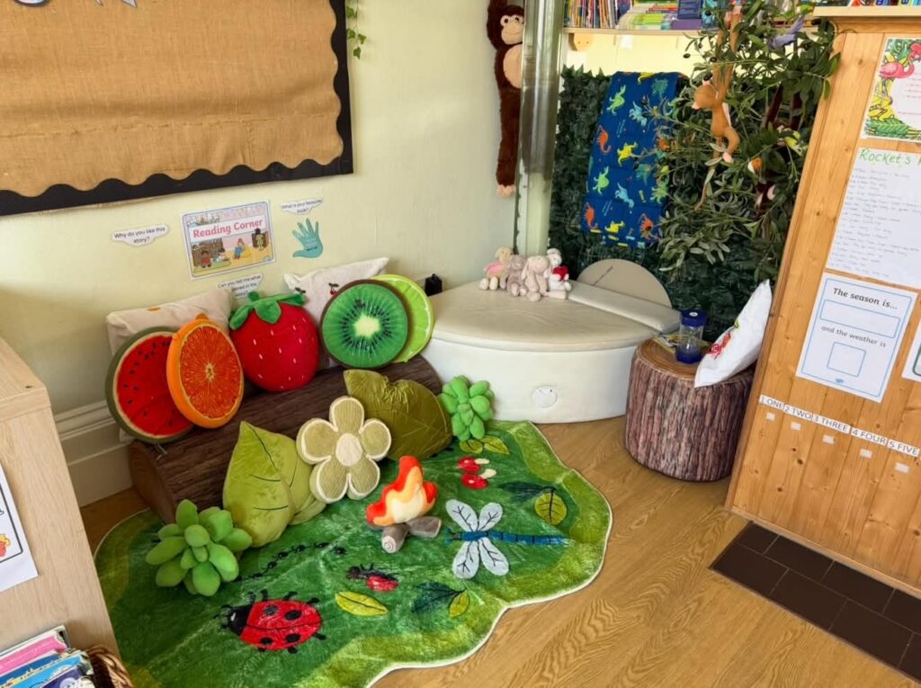 Fruit-shaped cushions and a ladybird rug in a jungle-themed corner