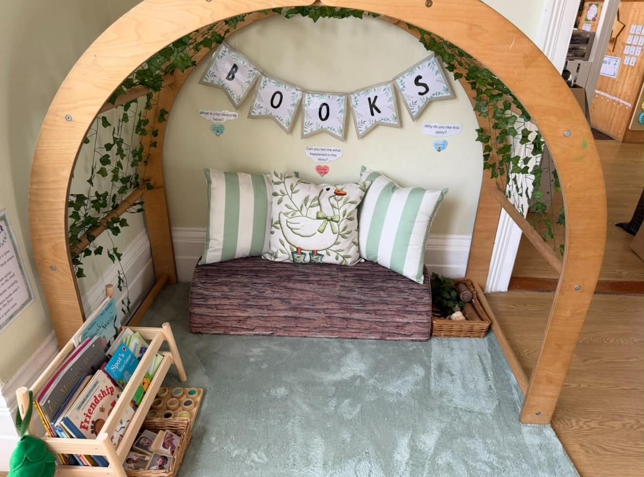 Green reading nook with a wooden books arch