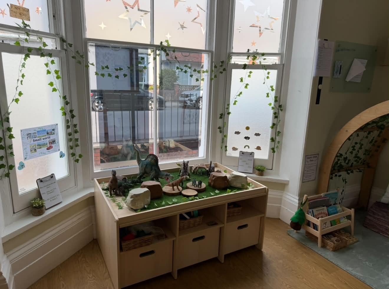 Small-world dinosaur table by the window